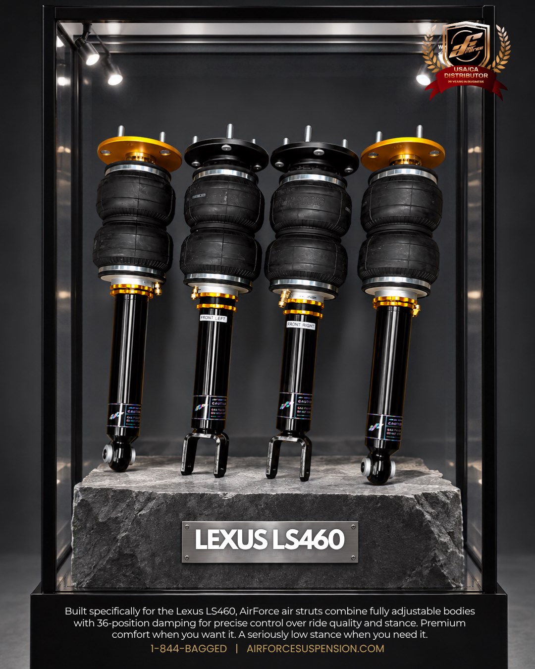 Lexus LS460 struts displayed inside a lit glass case on a stone plinth